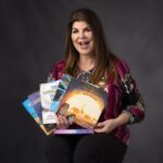 headshot of diann boehm holding all her books