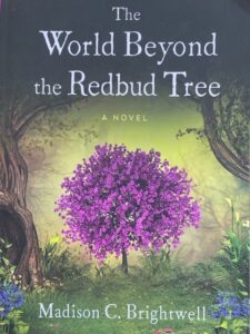 book cover for the world beyond the redbud tree