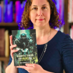 headshot photo of author KC Grifant with copy of shrouded horror