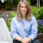 photo of author Laurie Trumble Davis sitting on outside chair